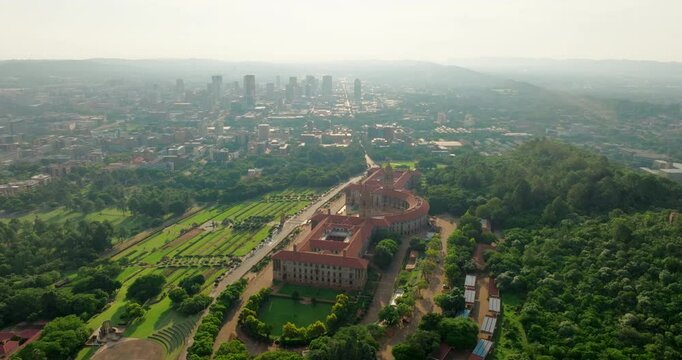 Union Buildings Aerial in Pretoria - Political Landmark in South Africa capital cityscape. Establishing shot of Government Office with gardens. 4K wide orbit video with Downtown Skyline