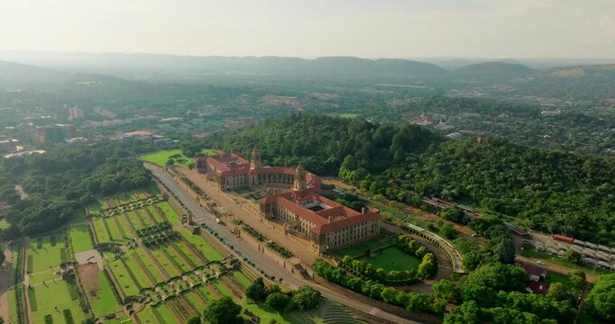Union Buildings Aerial in Pretoria - Political Landmark in South Africa capital. Establishing shot of Government Office with gardens and scenic landscape. 4K wide orbit video with Downtown Skyline