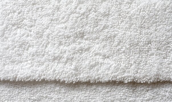 Close-up of a white terry towel texture with looped fabric.