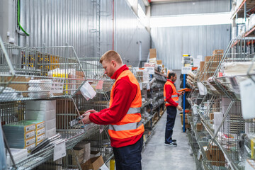 Warehouse workers are checking and organizing goods, ensuring efficient inventory management and logistics within a distribution center