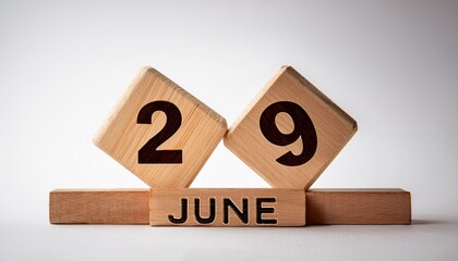 Minimalist photo of wooden blocks with date 29 June. Day and month, calendar on white background