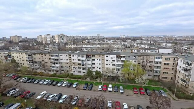 Depressing communist architecture overview in Eastern Europe , Romania , showing many rows of grey looking blocks , typical urban landscape