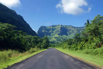 Naklejka premium Open asphalt road surrounded by natural green mountains under a clear blue sky