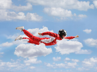 Car racer in a red suit flying