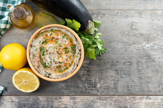 Traditional baba ganoush in bowl on wooden table. Top view. Copy space