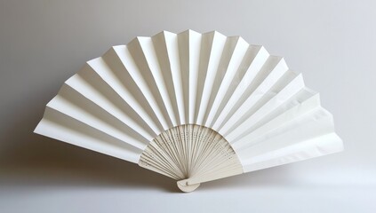 Elegant white paper fan.  A simple,  folded paper fan,  ideal for  a display or  gift.  The fan's  smooth,  white  surface  and  light-colored  handle create a  peaceful  aesthetic