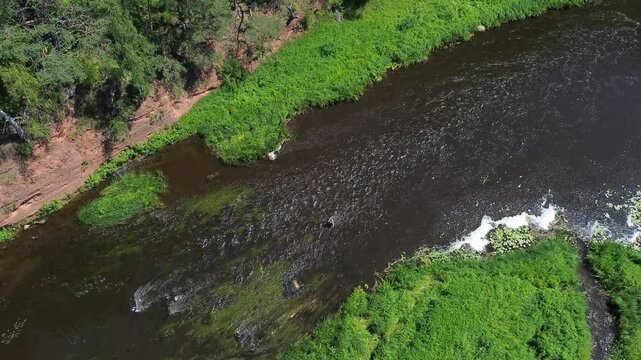 River side drone view next to red cliffs