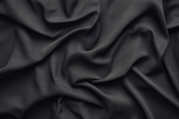 Fototapeta premium black fabric with textured surface is elegantly draped, creating soft folds and shadows. material smooth texture and dark color evoke sense of sophistication and depth