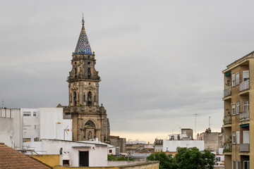 the intricate architecture of a church spire, rising over the rooftops of Jerez, southern Spain, on a rare overcast day in Andalusia