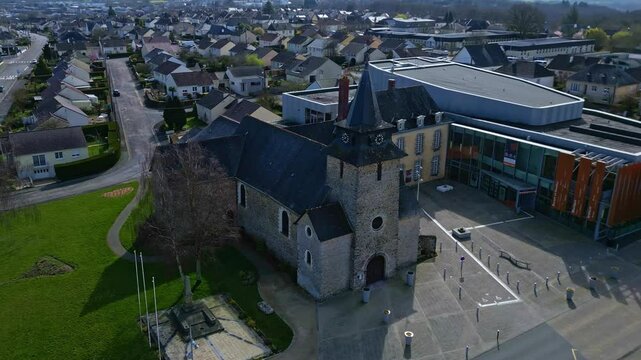 Eglise Saint Berthevin church and cultural center Le Reflet, cityscape, Mayenne department in France. Aerial drone circling