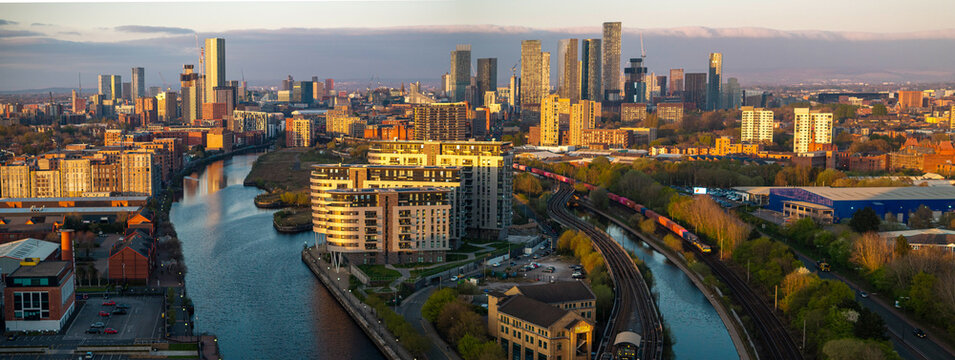 Panoramic aerial image of Manchester skyline at Sunset featuring river Irwell and Manchester canal 