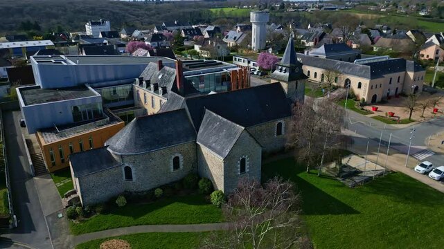 Eglise Saint Berthevin church and cultural center Le Reflet, Mayenne department in France. Aerial drone orbiting