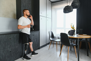 Portrait of a young man with a prosthetic leg at home