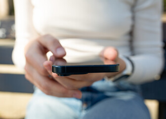 Closeup of woman hands using smartphone
