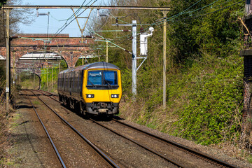 Fototapeta premium British train in the railway traveling towards a station. 
