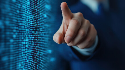 business professional pointing at digital screen displaying data. image conveys sense of technology and innovation in corporate environment