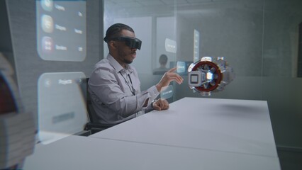 African American Engineer Uses Augmented Reality Headset to Visualize 3D Holographic Model of Renewable Energy Engine. Virtual Visualization of Design Software Based on Artificial Intelligence.