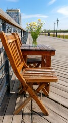 Fototapeta premium Sunny day by the river with wooden table and chairs decorated with fresh flowers in a peaceful outdoor setting