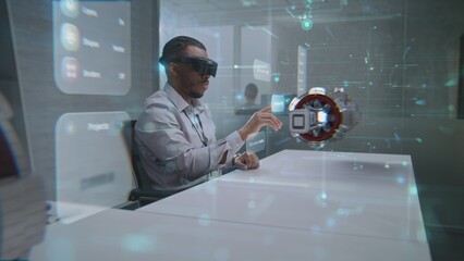 Futuristic Office: African American Professional Wearing Virtual Reality Headset to Visualize 3D...