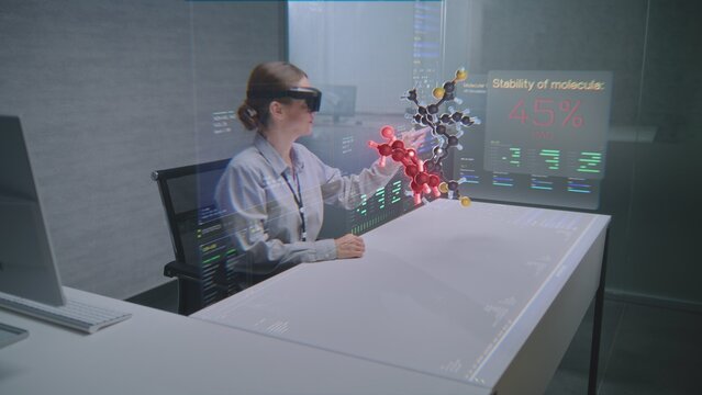 Female Professional Uses Augmented Reality Headset to Visualize 3D Hologram of Molecular Compounds in Advanced Office. Virtual Visualization of Artificial Intelligence Based Software Interface.