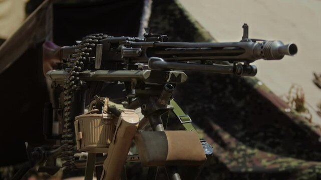 German MG42 Machine Gun with Ammunition belt on Tripod at World War II Reenactment. Close up of iconic WWII general-purpose weapon mounted for sustained fire. Wehrmacht Army firearm Military equipment