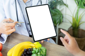 Nutrition and Technology. A healthcare professional presenting a tablet to a patient, integrating...