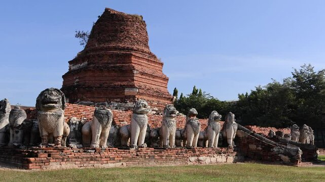 Footage of Bell Shaped Chedi's Ruin Surrounded by 52 Lion Statues of Wat Thammikarat Buddhist Temple, Ayutthaya Historical Park, Thailand