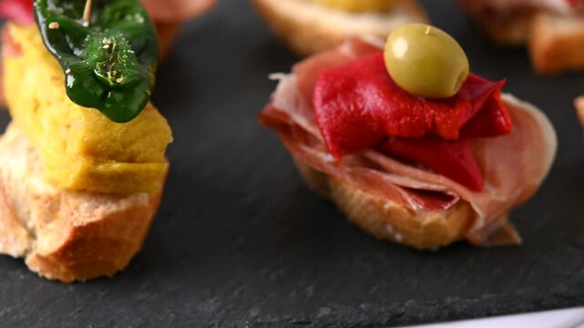 Traditional Spanish pintxos on wooden table