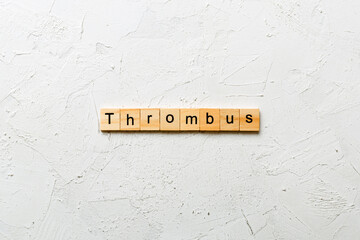 thrombus word written on wood block. thrombus text on table, concept