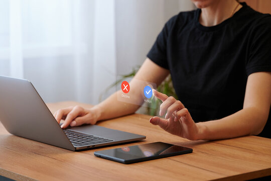 The choice is between accept or reject. Virtual interface, laptop, and female hands. The choice in favor of acceptance