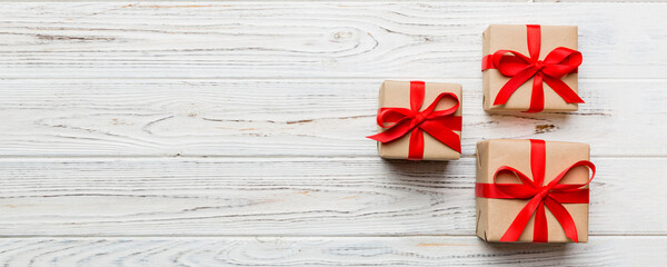 Valentine day composition: red gift box with bow and heart. Christmas present. View from above....