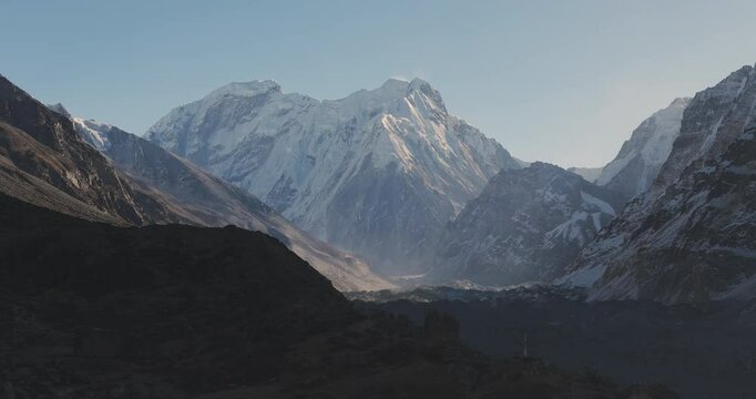 Telephoto drone shot of the snowy Kanchenjunga mountain, sunny day in Nepal