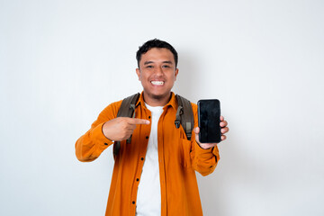 Image of handsome young Asian student using backpack and pointing smartphone on isolated white...