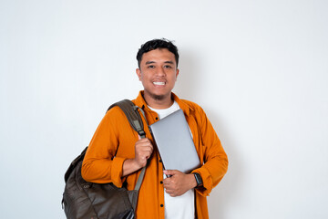 Image of handsome young Asian student holding laptop and using backpack on isolated white background