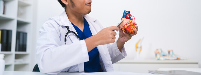 Banner of cardiologist used a stethoscope to check the heartbeat and pulse of an elderly person, as the doctor monitored for disease in the hospital's health care system.