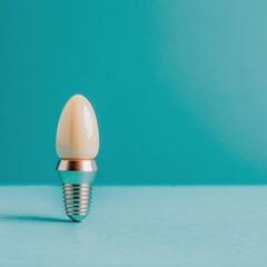 Minimalist light bulb on turquoise background showcasing energy efficiency and creative lighting solutions for modern design