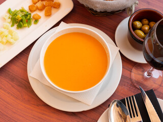 Popular Spanish dish is cold soup Gaspacho made from mashed raw vegetables. Served with freshly cut vegetables and crackers