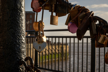 Love Locks Attached to a Railing Above Waterfront