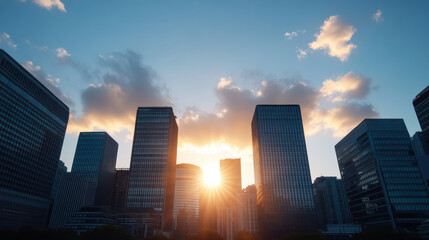 Obraz premium Sunset over modern skyscrapers creates stunning silhouette against sky