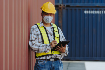 Asian or Japanese engineers are working and inspecting at a container port
