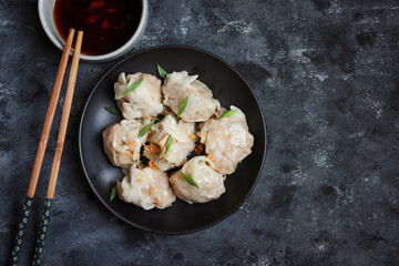 Chinese dumpling, dim sum food serve with soy sauce. Authentic asian food.