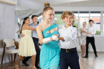 Boy and girl dance couples ballroom dance waltz in studio