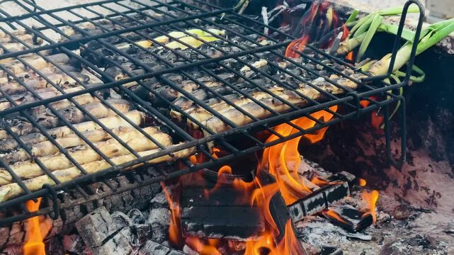 Cal&ccedil;ots cooking on the grill, Mediterranean traditional dish.