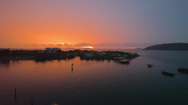 Kota Kinabalu Sunset Over Sea With Moored Docked Sailboats and Trawler Boats by Sutera Resorts Harbor. Sun Hides Behide Manukan Island - Aerial static