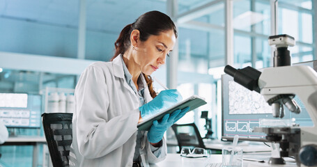 Scientist, woman and tablet with digital notes for biology, innovation or medical research...