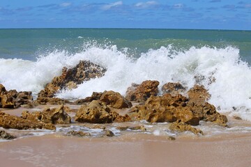 White foam on the air, sea water splashing when  crashing rock on the beach. Coqqueiros beach near Joao Pessoa, Brazil northeast. 