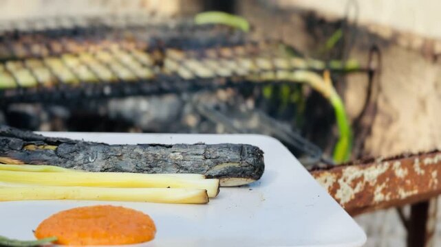 Plate of grilled cal&ccedil;ots served with traditional romesco sauce.