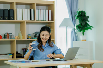 A female staff member pauses from work to sip her coffee and recharge.