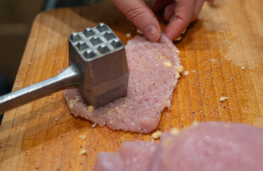 Tenderize meat, beating, hammering fillet pieces, cooking schnitzel process closeup