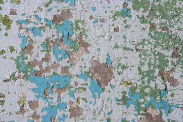 Peeling paint on the wall. Old concrete wall with cracked flaking paint. Weathered rough painted...